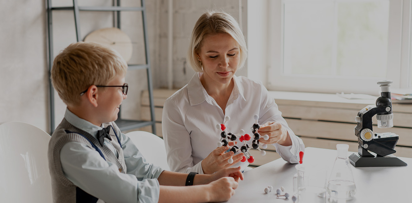 Female science tutor in Sugarland studying chemistry with student